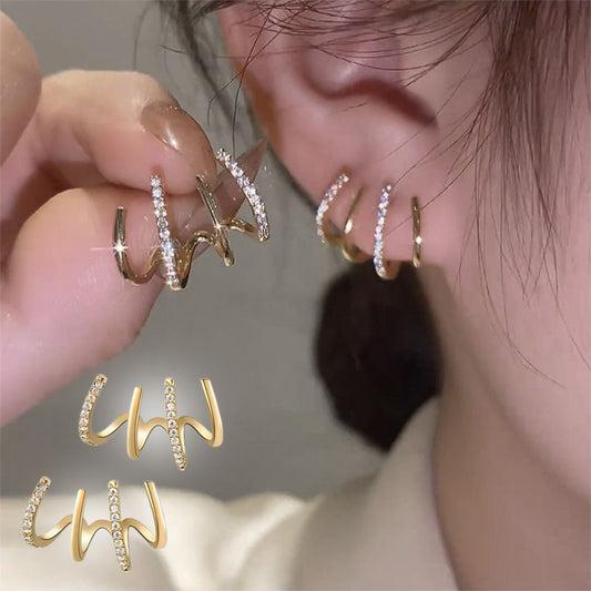 Par de aretes de garra bañados en oro con circonitas